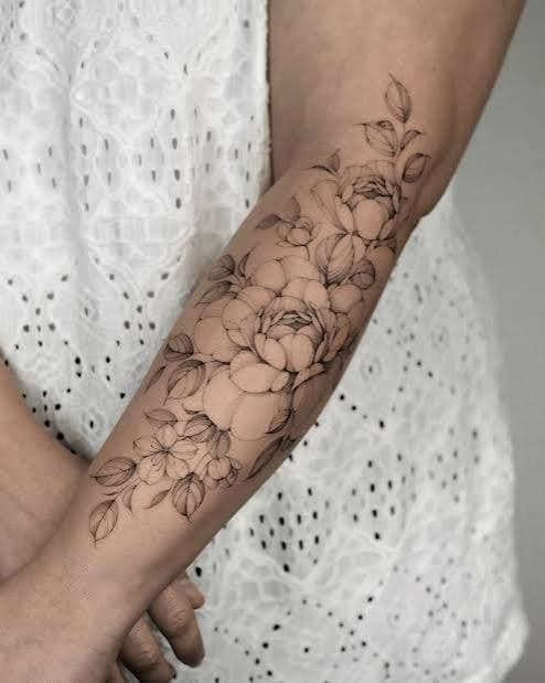 Fine-line botanical forearm tattoo