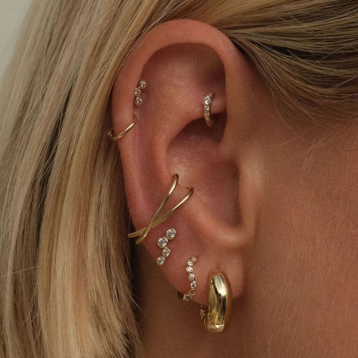 Delicate ear curation with gold jewelry